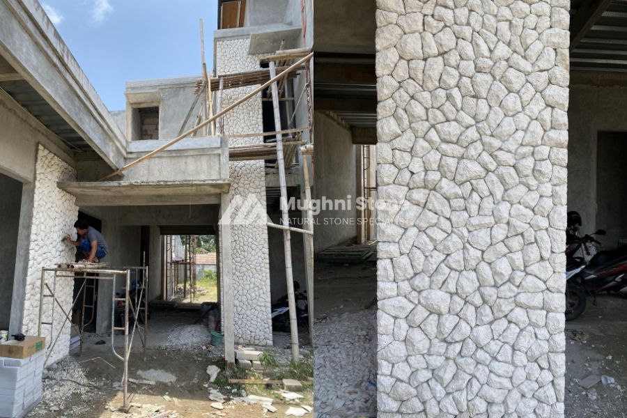 Pilar batu limestone putih cerah pada rumah bergaya Mediterania dengan pencahayaan lembut